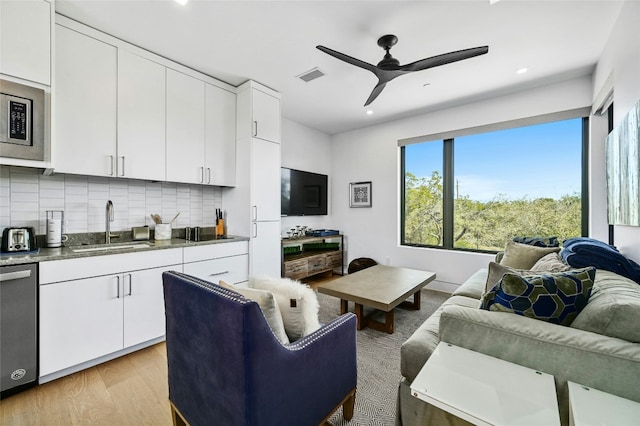 8209 Two Coves Dr, Austin, TX 78730 - living room with light wood finished floors, ceiling fan, and recessed lighting