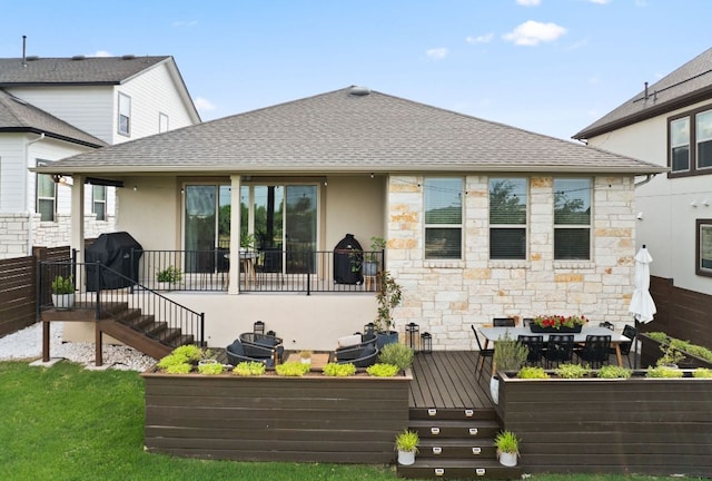 7105 Jument Dr, Austin, TX 78738 - rear view of property with stone siding, stucco siding, a shingled roof, and a wooden deck