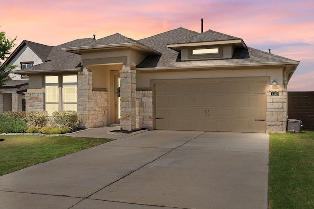 7105 Jument Dr, Austin, TX 78738 - view of front of home featuring stone siding, a garage, driveway, and roof with shingles