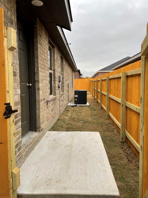 2313 Zanoletti Ct, Temple, TX 76504 - fenced backyard featuring central AC unit and a patio area