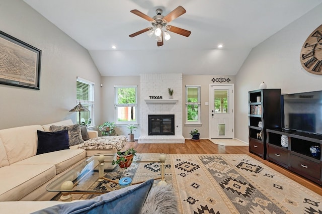 10603 Watchful Fox Dr, Austin, TX 78748 - living room featuring lofted ceiling, wood finished floors, ceiling fan, a brick fireplace, and recessed lighting