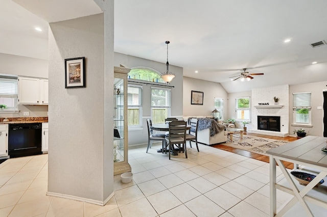 10603 Watchful Fox Dr, Austin, TX 78748 - living area with ceiling fan, vaulted ceiling, light tile patterned floors, a fireplace, and baseboards