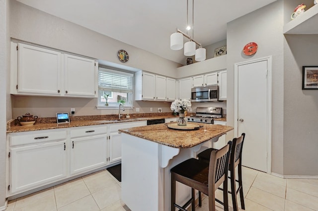 10603 Watchful Fox Dr, Austin, TX 78748 - kitchen featuring appliances with stainless steel finishes, a sink, light tile patterned floors, and light stone countertops