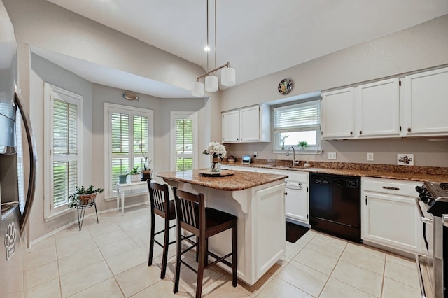 10603 Watchful Fox Dr, Austin, TX 78748 - kitchen featuring dishwasher, stainless steel gas range oven, fridge, a center island, and white cabinetry