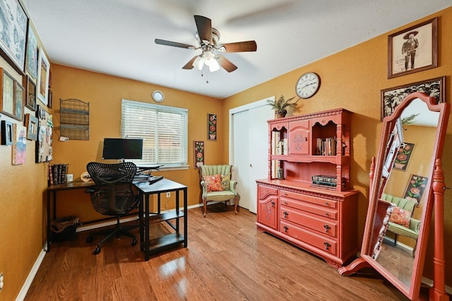 10603 Watchful Fox Dr, Austin, TX 78748 - office featuring light wood-style flooring, ceiling fan, baseboards, and a textured wall
