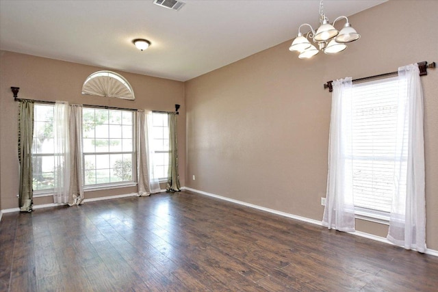 102 Cavalry Trl, Elgin, TX 78621 - empty room featuring a chandelier, dark wood-style floors, and baseboards
