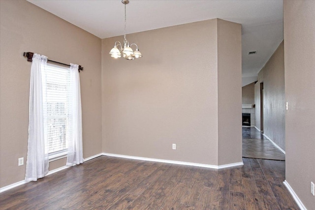 102 Cavalry Trl, Elgin, TX 78621 - empty room with a chandelier, wood finished floors, plenty of natural light, and baseboards
