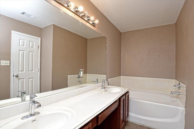 102 Cavalry Trl, Elgin, TX 78621 - full bathroom with double vanity and a garden tub