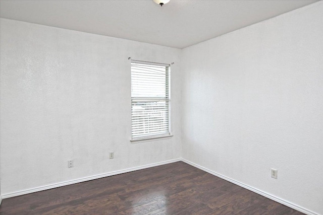 102 Cavalry Trl, Elgin, TX 78621 - spare room featuring dark wood finished floors and baseboards