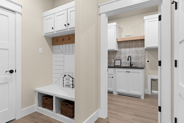 4374 Tall Rdg, Kempner, TX 76539 - mudroom with a sink, baseboards, and light wood-style flooring