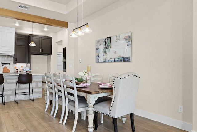 4374 Tall Rdg, Kempner, TX 76539 - dining room featuring light wood-style flooring, beam ceiling, and baseboards