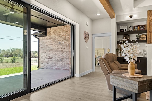 4374 Tall Rdg, Kempner, TX 76539 - living area featuring light wood-style flooring, beam ceiling, brick wall, and baseboards
