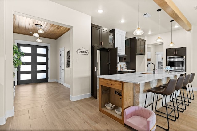4374 Tall Rdg, Kempner, TX 76539 - kitchen with baseboards, a sink, wooden ceiling, a large island, and a breakfast bar area