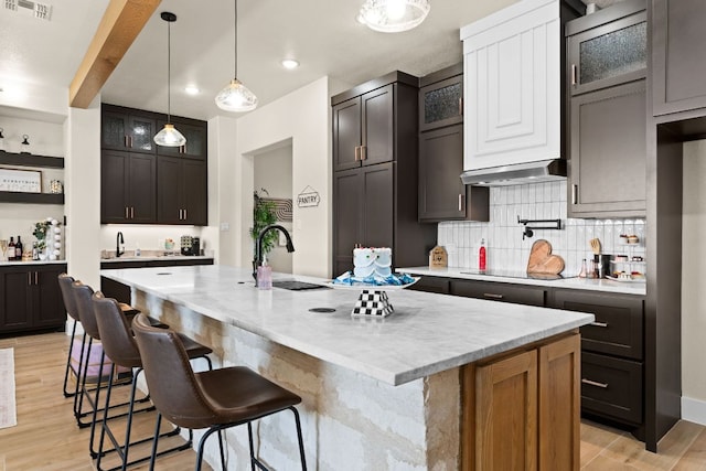 4374 Tall Rdg, Kempner, TX 76539 - kitchen featuring a sink, light wood-type flooring, decorative backsplash, an island with sink, and recessed lighting