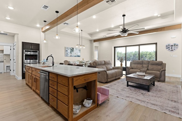 4374 Tall Rdg, Kempner, TX 76539 - kitchen featuring appliances with stainless steel finishes, a tray ceiling, open floor plan, a sink, and recessed lighting