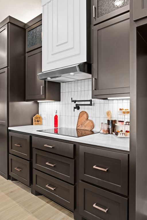 4374 Tall Rdg, Kempner, TX 76539 - kitchen featuring light countertops, backsplash, and ventilation hood