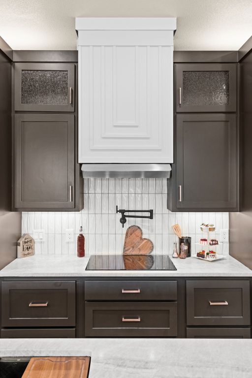 4374 Tall Rdg, Kempner, TX 76539 - kitchen with light countertops, glass insert cabinets, and tasteful backsplash