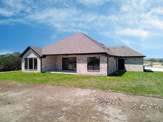4374 Tall Rdg, Kempner, TX 76539 - rear view of house featuring brick siding, a yard, a shingled roof, and a patio