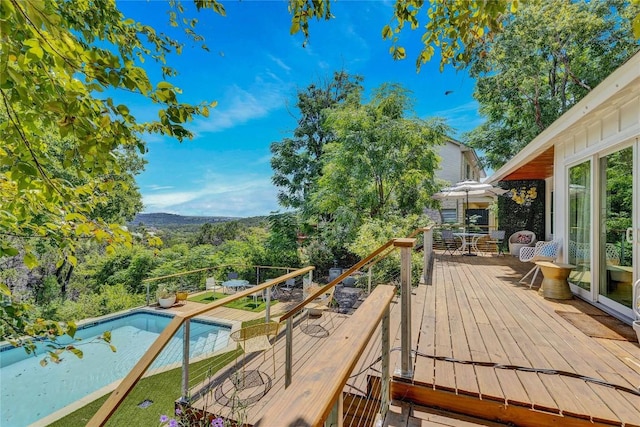 2419 Trail Of The Madrones, Austin, TX 78746 - wooden deck with an outdoor pool and outdoor dining area