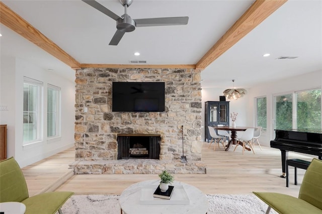 2419 Trail Of The Madrones, Austin, TX 78746 - living area with beamed ceiling, wood finished floors, ceiling fan, recessed lighting, and a fireplace