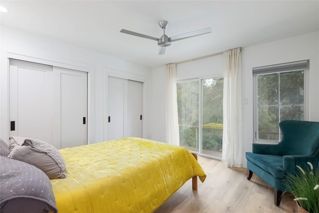 2419 Trail Of The Madrones, Austin, TX 78746 - bedroom featuring access to exterior, light wood-style floors, two closets, and a ceiling fan
