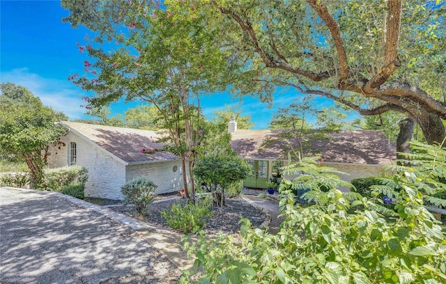 2419 Trail Of The Madrones, Austin, TX 78746 - view of front of home with a chimney