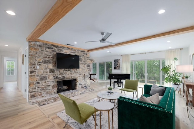 2419 Trail Of The Madrones, Austin, TX 78746 - living room featuring a ceiling fan, a stone fireplace, wood finished floors, and recessed lighting