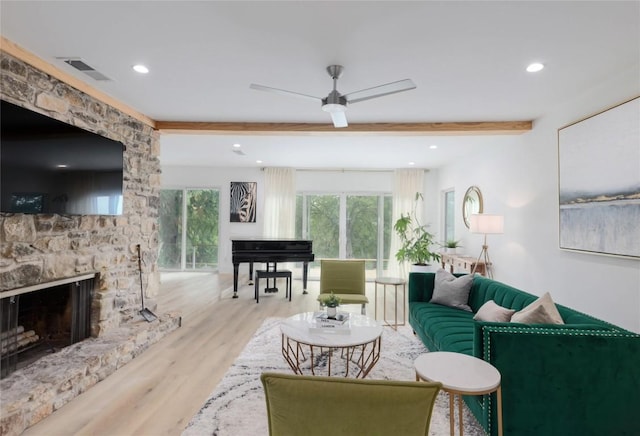 2419 Trail Of The Madrones, Austin, TX 78746 - living room featuring beamed ceiling, wood finished floors, a ceiling fan, a stone fireplace, and recessed lighting