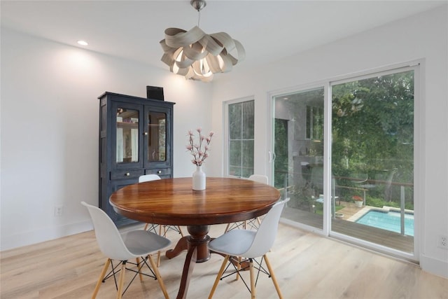 2419 Trail Of The Madrones, Austin, TX 78746 - dining room with a chandelier, light wood-style floors, and recessed lighting