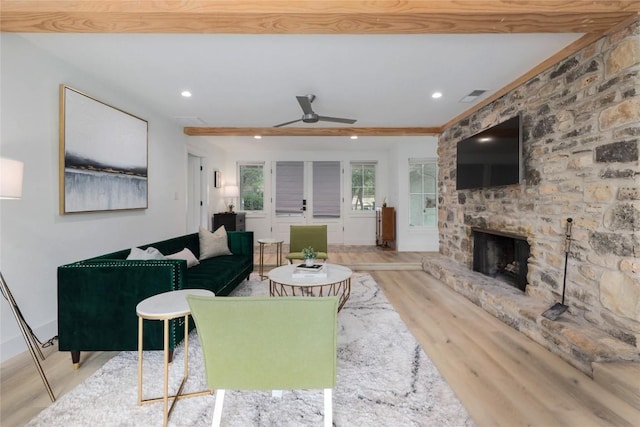 2419 Trail Of The Madrones, Austin, TX 78746 - living area featuring wood finished floors, a ceiling fan, a stone fireplace, recessed lighting, and ornamental molding