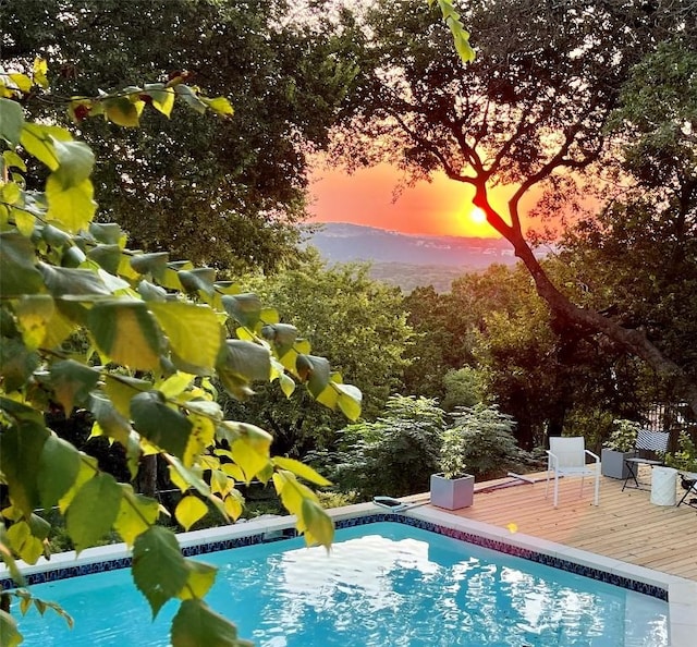 2419 Trail Of The Madrones, Austin, TX 78746 - pool at dusk with a wooden deck and an outdoor pool