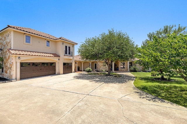 17308 Saint Therese Rd, Manor, TX 78653 - mediterranean / spanish-style home with a garage, driveway, a tile roof, stucco siding, and a front lawn