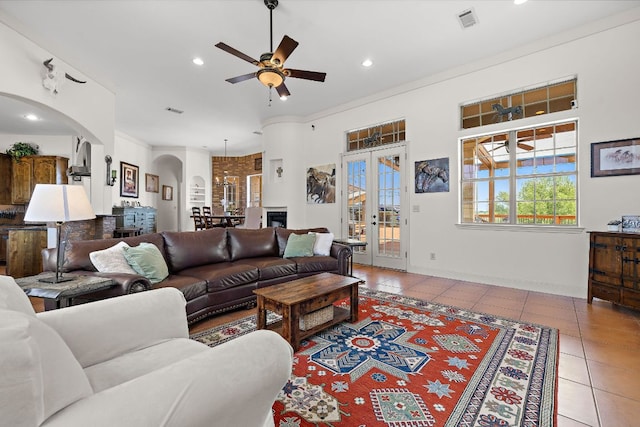 17308 Saint Therese Rd, Manor, TX 78653 - living area featuring arched walkways, a ceiling fan, light tile patterned floors, recessed lighting, and french doors