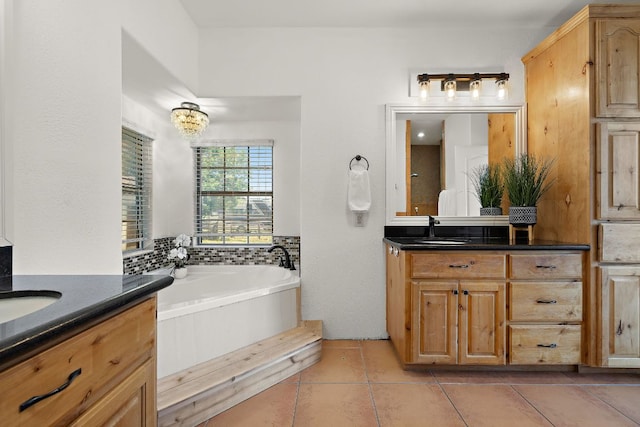 17308 Saint Therese Rd, Manor, TX 78653 - full bathroom featuring two vanities, a bath, and tile patterned flooring