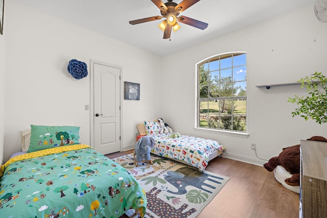 17308 Saint Therese Rd, Manor, TX 78653 - bedroom featuring wood finished floors, baseboards, and ceiling fan