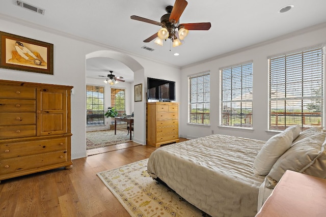 17308 Saint Therese Rd, Manor, TX 78653 - bedroom with crown molding, wood finished floors, access to outside, arched walkways, and recessed lighting