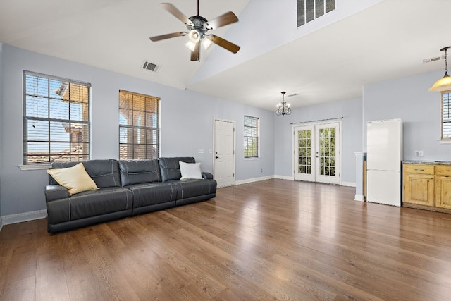 17308 Saint Therese Rd, Manor, TX 78653 - living room featuring ceiling fan, a chandelier, wood finished floors, and high vaulted ceiling