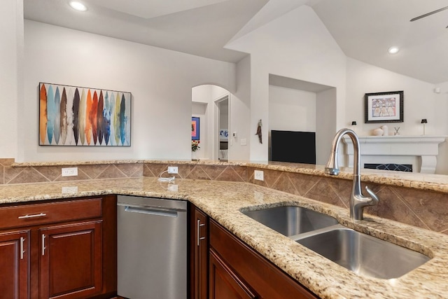 114 Fred Couples Dr, Round Rock, TX 78664 - kitchen featuring a sink, stainless steel dishwasher, open floor plan, light stone countertops, and vaulted ceiling