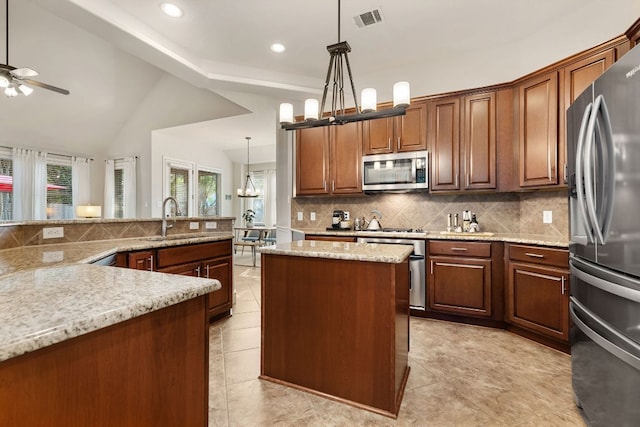 114 Fred Couples Dr, Round Rock, TX 78664 - kitchen featuring stainless steel appliances, a sink, a center island, decorative backsplash, and a ceiling fan