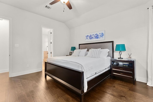 114 Fred Couples Dr, Round Rock, TX 78664 - bedroom featuring dark wood-style floors, baseboards, vaulted ceiling, ensuite bath, and a ceiling fan