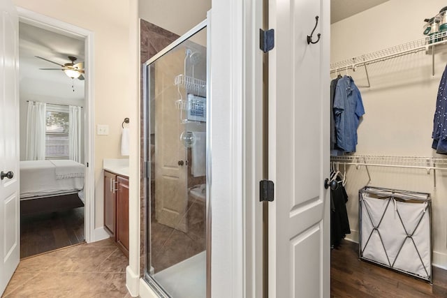 114 Fred Couples Dr, Round Rock, TX 78664 - full bath featuring a shower stall, ceiling fan, a walk in closet, and vanity