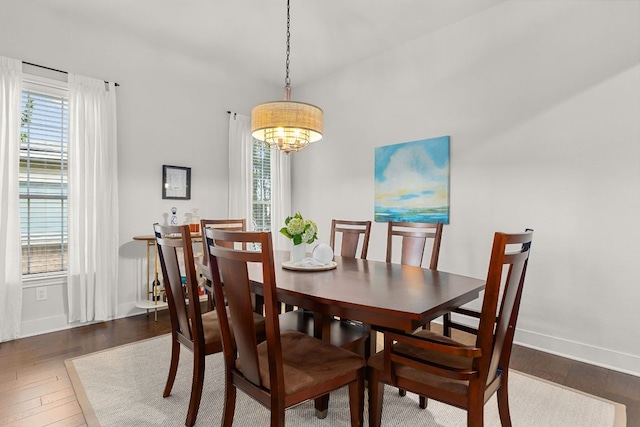 114 Fred Couples Dr, Round Rock, TX 78664 - dining room with wood finished floors, baseboards, and a chandelier