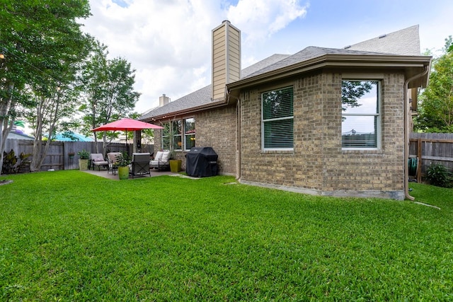 114 Fred Couples Dr, Round Rock, TX 78664 - back of house featuring a chimney, a patio, brick siding, and a shingled roof