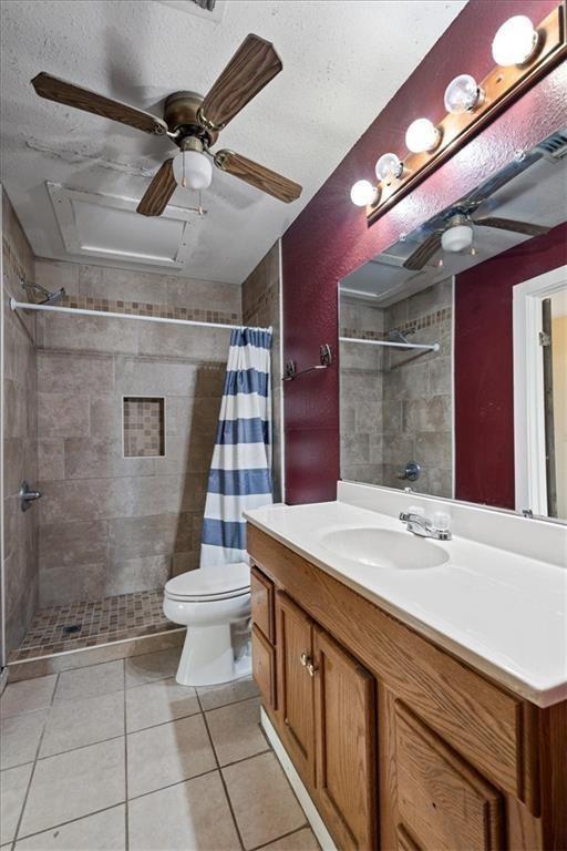 461 Skyline Rdg, San Marcos, TX 78666 - bathroom with toilet, tiled shower, vanity, ceiling fan, and tile patterned floors