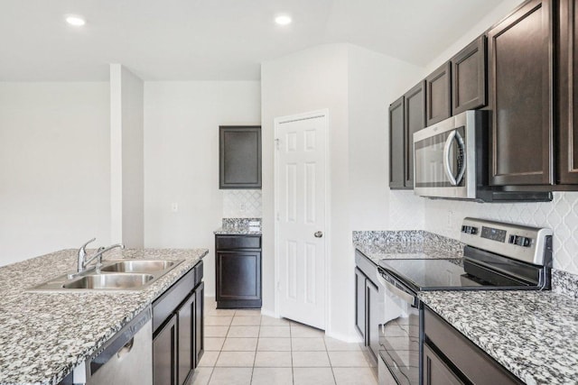 9701 Kensley Rose Dr, Killeen, TX 76542 - kitchen featuring appliances with stainless steel finishes, a sink, dark brown cabinetry, tasteful backsplash, and light tile patterned flooring