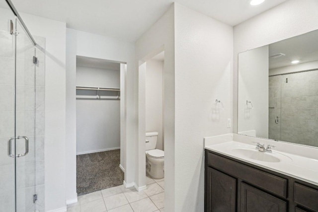9701 Kensley Rose Dr, Killeen, TX 76542 - full bath with a spacious closet, a stall shower, toilet, tile patterned floors, and vanity