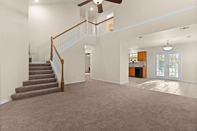 10 Saul St, Lampasas, TX 76550 - unfurnished living room with a ceiling fan, stairs, light colored carpet, a high ceiling, and light tile patterned floors