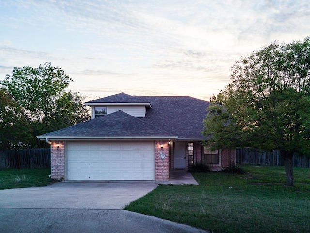 10 Saul St, Lampasas, TX 76550 - traditional-style house with driveway, an attached garage, brick siding, and roof with shingles
