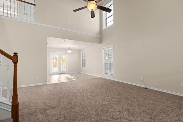 10 Saul St, Lampasas, TX 76550 - unfurnished living room featuring light carpet, ceiling fan, a high ceiling, and stairs