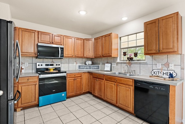 10 Saul St, Lampasas, TX 76550 - kitchen with appliances with stainless steel finishes, a sink, light tile patterned flooring, backsplash, and recessed lighting